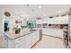 Bright kitchen featuring white cabinetry, granite counters, stainless steel appliances, and an island with pendant lighting at 4463 Cromey Rd, North Port, FL 34288