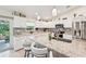 Bright kitchen featuring granite counters, white cabinets, stainless appliances, and counter seating at 4463 Cromey Rd, North Port, FL 34288