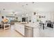 Bright kitchen featuring white cabinets, granite counters, stainless steel appliances, and a large center island at 4463 Cromey Rd, North Port, FL 34288