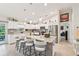 Modern kitchen with white cabinetry, stainless steel appliances, granite countertops, and a large island with bar seating at 4463 Cromey Rd, North Port, FL 34288