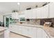 Beautiful kitchen with white cabinetry, granite counters, tile backsplash, and stainless steel appliances at 4463 Cromey Rd, North Port, FL 34288