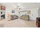 Cozy living room with tile floors, ceiling fan, decorative window treatment, and ample space for relaxation at 4463 Cromey Rd, North Port, FL 34288