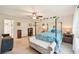 Comfortable main bedroom with a canopy bed, ceiling fan, and an ensuite bathroom at 4463 Cromey Rd, North Port, FL 34288