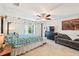 Spacious main bedroom with a canopy bed, ceiling fan, and large window with natural light at 4463 Cromey Rd, North Port, FL 34288