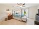Bright main bedroom featuring a canopy bed, ceiling fan, and tile floors at 4463 Cromey Rd, North Port, FL 34288