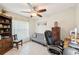A cozy office space with an adjustable desk, bookcase, and natural light at 4463 Cromey Rd, North Port, FL 34288