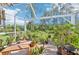 Screened patio area with brick floor, lush greenery, and view of trees at 4463 Cromey Rd, North Port, FL 34288