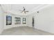 Bedroom with tray ceilings, tile flooring, large windows for natural light, and access to the outdoors at 4676 Tuscana Dr, Sarasota, FL 34241