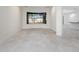 Spacious bonus room with tile flooring and large windows showcasing outdoor views at 4676 Tuscana Dr, Sarasota, FL 34241