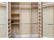 Spacious walk-in closet providing ample storage, featuring open shelving with metal rods at 4676 Tuscana Dr, Sarasota, FL 34241