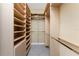 Walk-in closet with custom shelving and ample storage space for clothes and accessories at 4676 Tuscana Dr, Sarasota, FL 34241