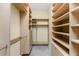 Walk-in closet providing plenty of storage with built-in shelving and drawers at 4676 Tuscana Dr, Sarasota, FL 34241