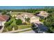 Beautiful single-story home with manicured landscaping, three-car garage and a tile roof at 4676 Tuscana Dr, Sarasota, FL 34241