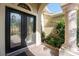 Elegant double door entry with decorative glass and a stone column at 4676 Tuscana Dr, Sarasota, FL 34241