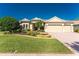 Stunning single-story home with a well-manicured lawn, mature trees and a three car garage at 4676 Tuscana Dr, Sarasota, FL 34241