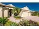 Beautiful front entrance with a brick paved driveway and lush tropical landscaping at 4676 Tuscana Dr, Sarasota, FL 34241