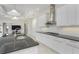 Clean kitchen design with center island, stainless hood, and black countertops at 4676 Tuscana Dr, Sarasota, FL 34241