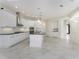 Bright, modern kitchen with a center island, stainless appliances and white cabinets at 4676 Tuscana Dr, Sarasota, FL 34241