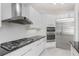Updated kitchen has stainless appliances, a gas cooktop, and black countertops at 4676 Tuscana Dr, Sarasota, FL 34241
