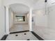 Spacious living room with tile flooring, columns, and view of entryway at 4676 Tuscana Dr, Sarasota, FL 34241