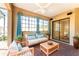 Cozy outdoor patio with comfortable seating, bright curtains and ceiling fan at 4676 Tuscana Dr, Sarasota, FL 34241