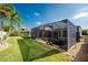 A screened-in pool area is nestled in a lush backyard at 4676 Tuscana Dr, Sarasota, FL 34241