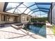 Screened-in pool with brick patio and unique water features at 4676 Tuscana Dr, Sarasota, FL 34241