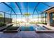 Relaxing screened-in pool area with brick pavers and lush tropical landscaping at 4676 Tuscana Dr, Sarasota, FL 34241