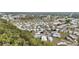 Aerial view shows the property in a wooded community with similar-style homes at 5488 Holiday Park Blvd, North Port, FL 34287
