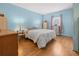 Bedroom with hardwood flooring, lamps, and wardrobe at 5488 Holiday Park Blvd, North Port, FL 34287