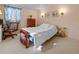 Comfortable bedroom features a bed, dresser, and bright natural light at 5488 Holiday Park Blvd, North Port, FL 34287