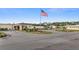 A community building in an active 55+ community with manicured landscaping and a U.S. flag at 5488 Holiday Park Blvd, North Port, FL 34287