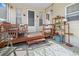 Cozy covered porch with wooden furniture, decor and ample seating at 5488 Holiday Park Blvd, North Port, FL 34287
