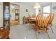 Open dining area with wooden table, bright lighting, and view into the kitchen at 5488 Holiday Park Blvd, North Port, FL 34287