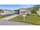 Charming single-story home featuring a screened porch and well-maintained front lawn at 5488 Holiday Park Blvd, North Port, FL 34287