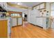 Functional kitchen featuring wood look floors, light colored cabinetry and plenty of natural light at 5488 Holiday Park Blvd, North Port, FL 34287