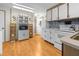 Cozy kitchen with white cabinetry, wood look flooring, and modern appliances at 5488 Holiday Park Blvd, North Port, FL 34287