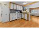 Cozy kitchen features wood floors, white cabinets and vintage backsplash at 5488 Holiday Park Blvd, North Port, FL 34287