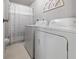 Clean laundry area with washer, dryer, and shower/tub at 5488 Holiday Park Blvd, North Port, FL 34287