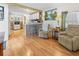 Inviting living room with wood floors, comfortable seating, and open kitchen access at 5488 Holiday Park Blvd, North Port, FL 34287