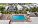 Aerial view of a community pool featuring lounge chairs on a brick patio deck at 5488 Holiday Park Blvd, North Port, FL 34287