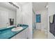 Clean bathroom with large mirror, white cabinets, and coordinated fixtures at 5640 Burdette Ter, North Port, FL 34287