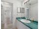 Bright bathroom with modern vanity, countertop, and ample lighting at 5640 Burdette Ter, North Port, FL 34287