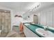Well-lit bathroom with double sinks, and neutral tiling at 5640 Burdette Ter, North Port, FL 34287