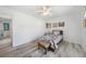 Bedroom featuring light wood floors, a ceiling fan, and access to the bathroom at 5640 Burdette Ter, North Port, FL 34287