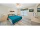 Comfortable bedroom featuring light wood floors and neutral walls at 5640 Burdette Ter, North Port, FL 34287