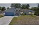 Well-maintained single-story home with blue accents and mature trees in a quiet neighborhood at 5640 Burdette Ter, North Port, FL 34287
