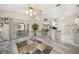 Open concept living space featuring wood-look floors, an open kitchen, and sliding glass doors at 5640 Burdette Ter, North Port, FL 34287