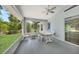 Covered patio featuring ample seating and a ceiling fan overlooking the green yard at 5640 Burdette Ter, North Port, FL 34287