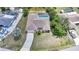 Aerial view of home with pool, complemented by lush landscaping and a private fenced backyard at 657 Hartford Nw Dr, Port Charlotte, FL 33952
